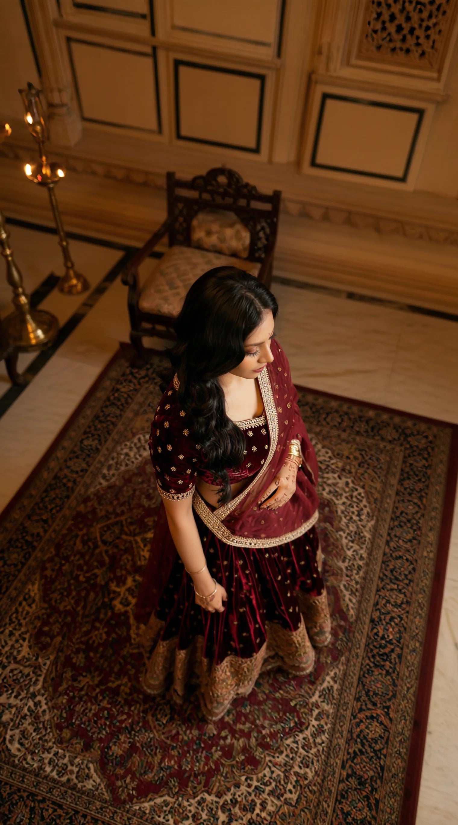 Deep maroon velvet lehenga with gold embroidered border, premium ethnic set by Saroj Jain.