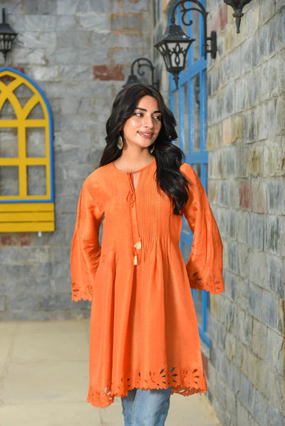 This orange Zari silk short flared kurta features a slit neckline and full flared sleeves, designed with a pull-up closure. Enhanced with elegant cutwork detailing, it offers a perfect blend of traditional charm and contemporary style—ideal for festive occasions.